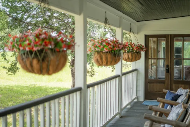 a living room with furniture a large window and a fireplace