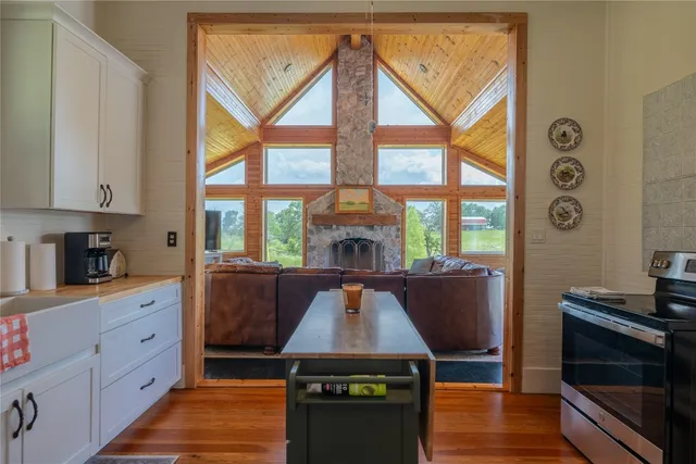 a kitchen with white cabinets and window