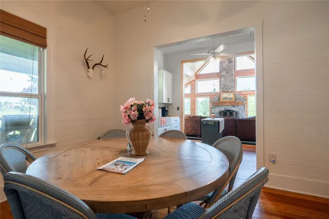 a view of a hallway to a livingroom with furniture and wooden floor