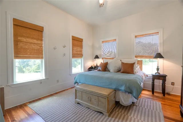 a bedroom with a bed chair and a window