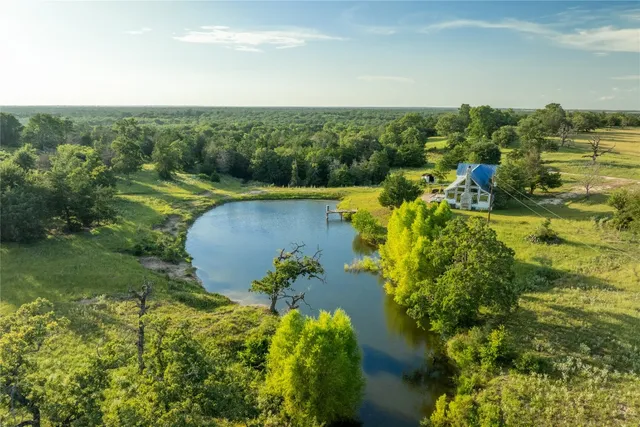 an aerial view of a houses with a yard