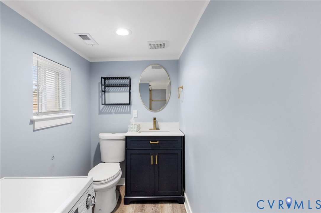 3061 Decatur Street Richmond, VA 23224 - Photo 18 of 23 a bathroom with a toilet sink vanity granite and mirror