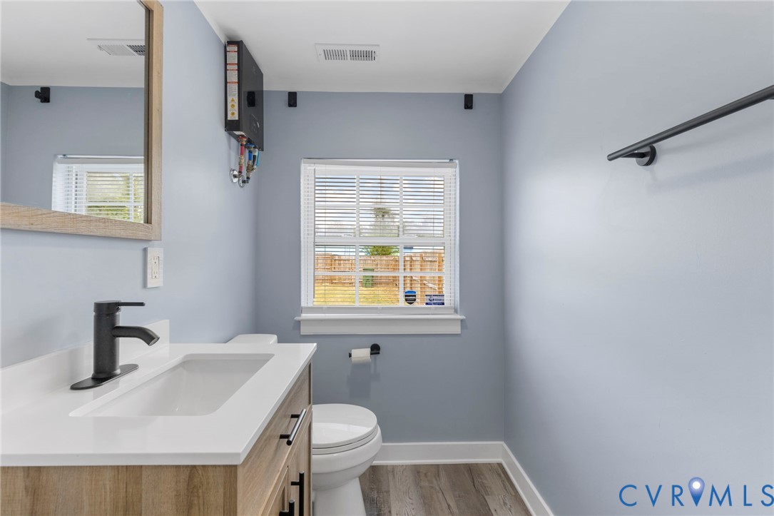 3061 Decatur Street Richmond, VA 23224 - Photo 19 of 23 a bathroom with a sink toilet and a mirror