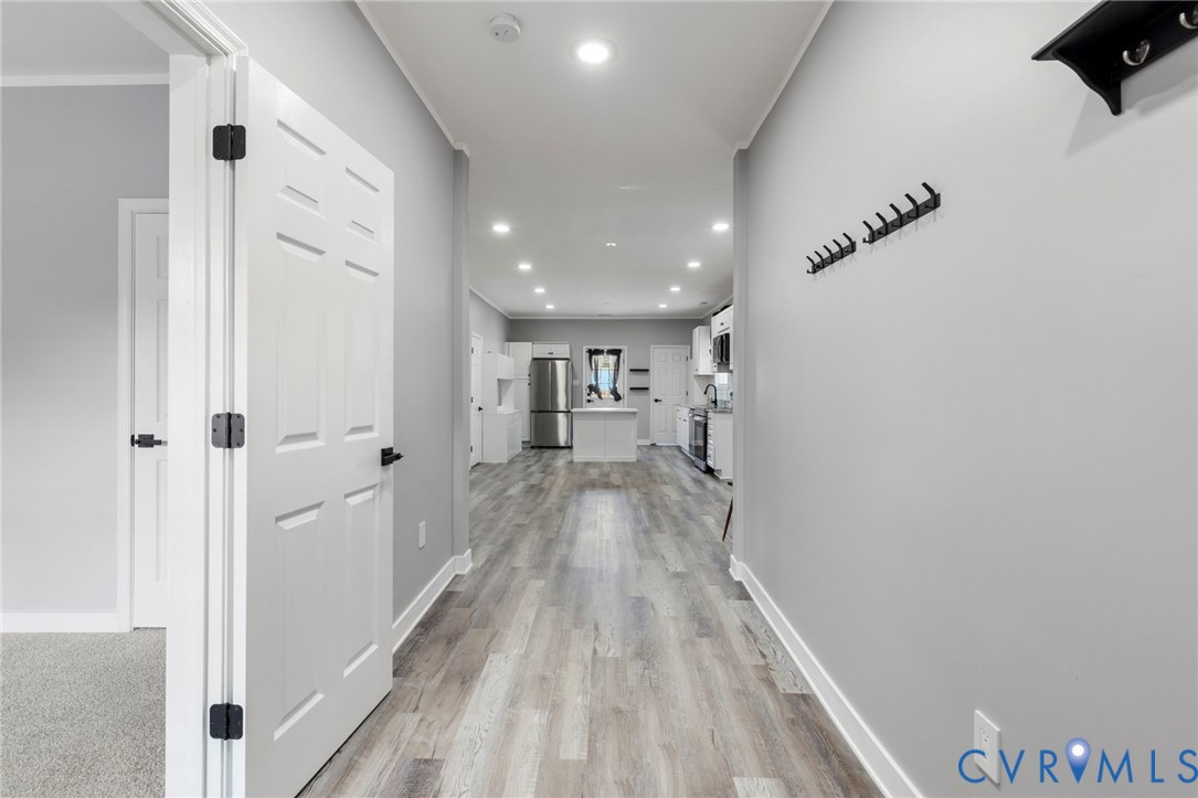 3061 Decatur Street Richmond, VA 23224 - Photo 5 of 23 a view of a hallway with wooden floor and staircase