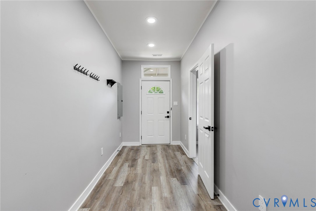 3061 Decatur Street Richmond, VA 23224 - Photo 6 of 23 a view of a hallway with wooden floor and a bathroom
