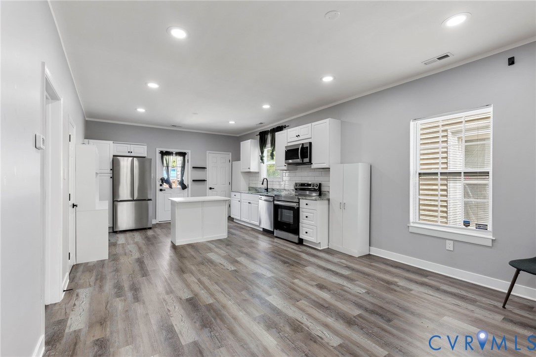 3061 Decatur Street Richmond, VA 23224 - Photo 9 of 23 a kitchen with white cabinets and stainless steel appliances