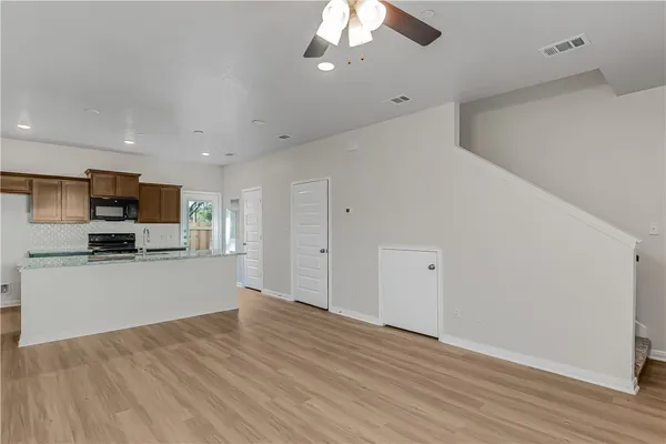 a view of a kitchen with microwave and cabinets