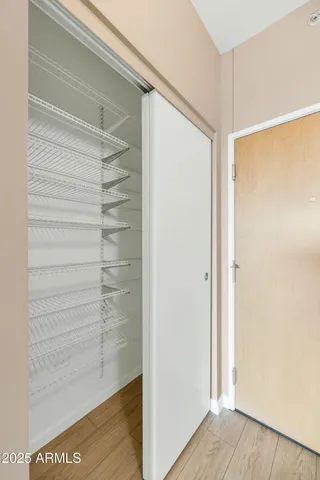 a view of walk in closet with empty racks