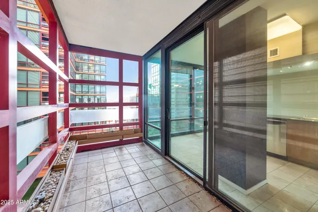 a view of empty room with wooden floor and windows