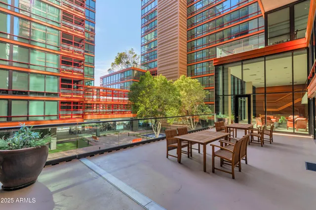 a view of a patio with a table and chairs and potted plants
