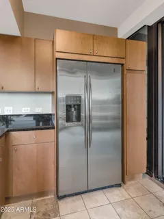 a metallic refrigerator freezer sitting in a kitchen