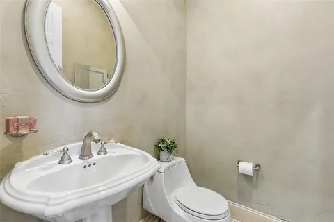 a bathroom with a sink a mirror and a toilet