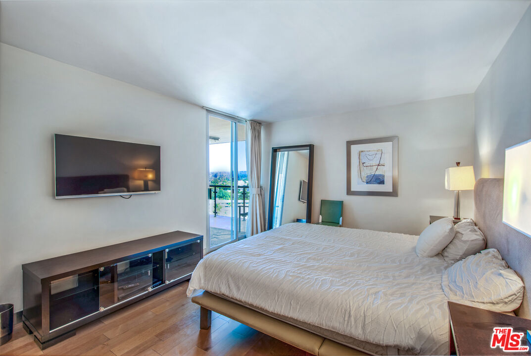 201 Ocean Avenue, Unit 1505B Santa Monica, CA 90402 - Photo 19 of 45 a bedroom with a bed and a flat screen tv