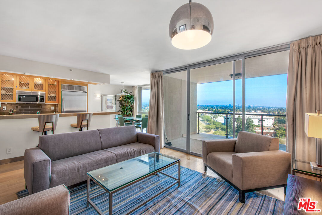 201 Ocean Avenue, Unit 1505B Santa Monica, CA 90402 - Photo 5 of 45 a living room with furniture and a large window