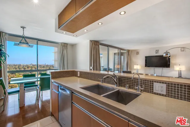 a kitchen with a sink and a stove top oven