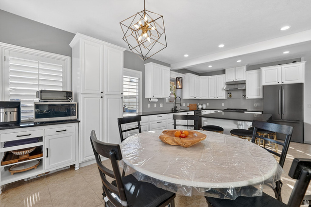 14738 Tangle Hill Road Herriman, UT 84096 - Photo 22 of 66 Modern kitchen featuring white shaker cabinetry and dark countertops