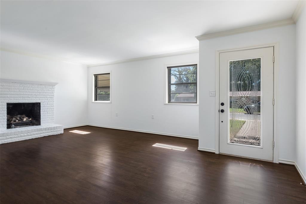 616 Laurel Road, Unit A Athens, TX 75751 - Photo 3 of 24 a view of an empty room with wooden floor and a window