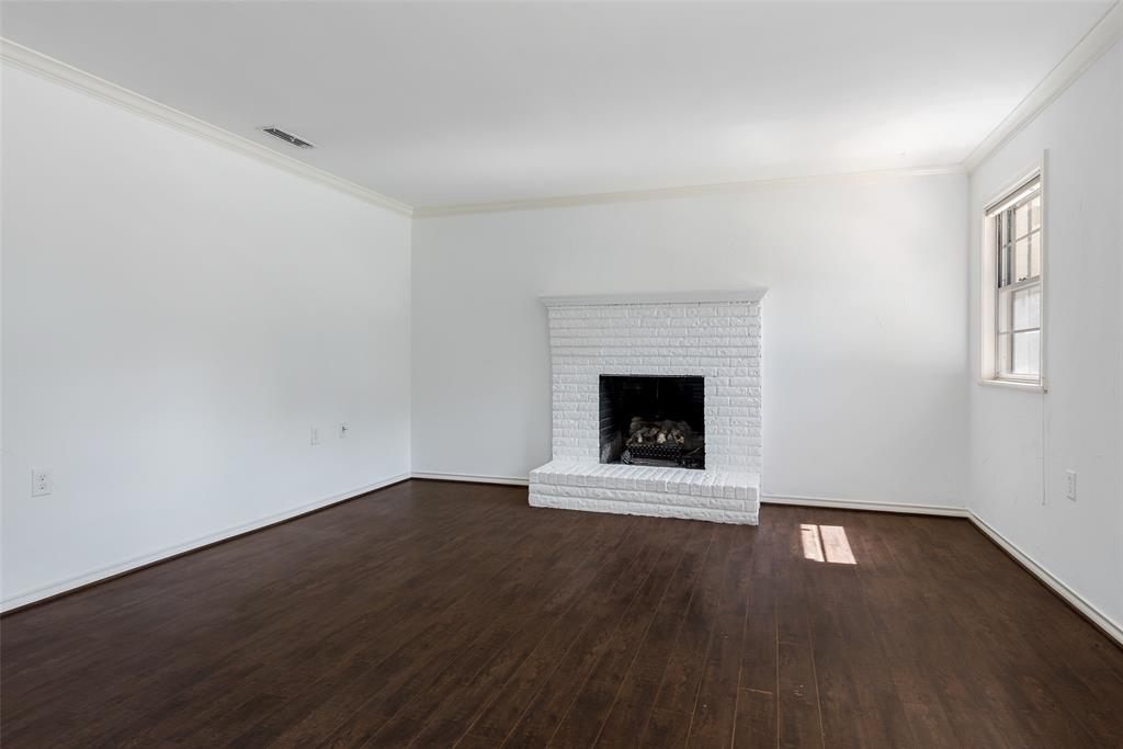 616 Laurel Road, Unit A Athens, TX 75751 - Photo 4 of 24 an empty room with wooden floor and fireplace