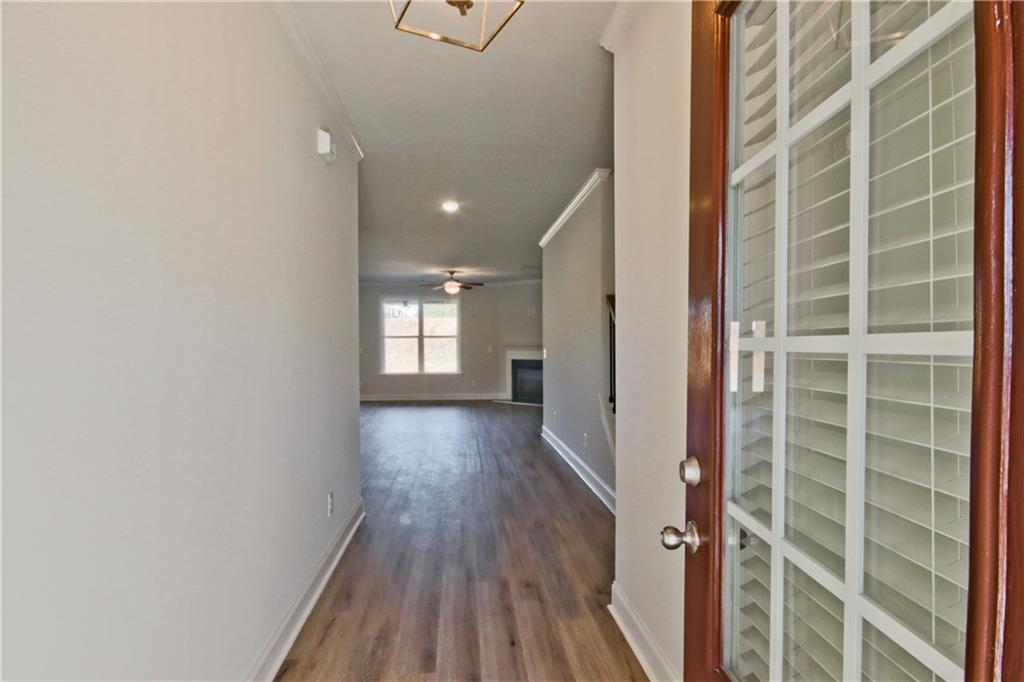 5984 Spring Way Lithonia, GA 30058 - Photo 1 of 37 a view of a hallway with wooden floor and a window
