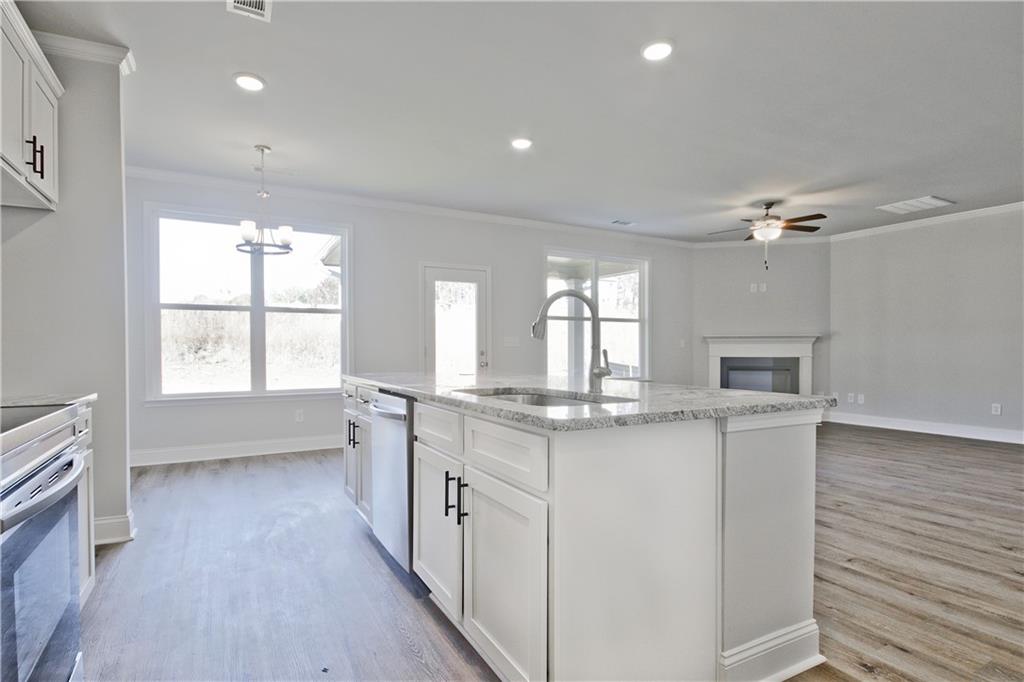 5984 Spring Way Lithonia, GA 30058 - Photo 16 of 37 a view of a kitchen with a sink and dishwasher next to a window
