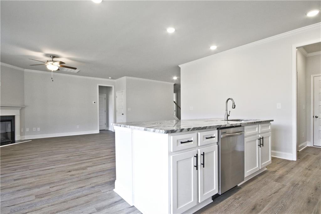 5984 Spring Way Lithonia, GA 30058 - Photo 17 of 37 a kitchen with stainless steel appliances granite countertop a stove and a sink