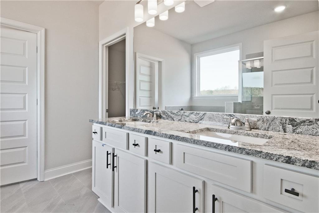 5984 Spring Way Lithonia, GA 30058 - Photo 23 of 37 a bathroom with a granite countertop sink and a mirror