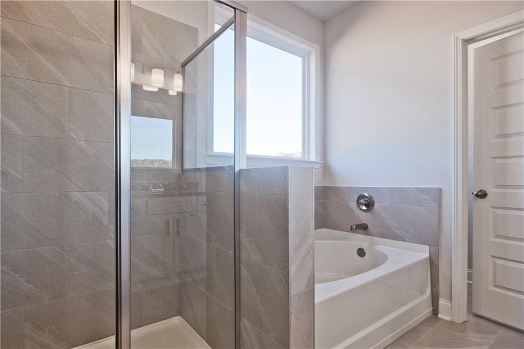 5984 Spring Way Lithonia, GA 30058 - Photo 25 of 37 a bathroom with a bathtub and shower
