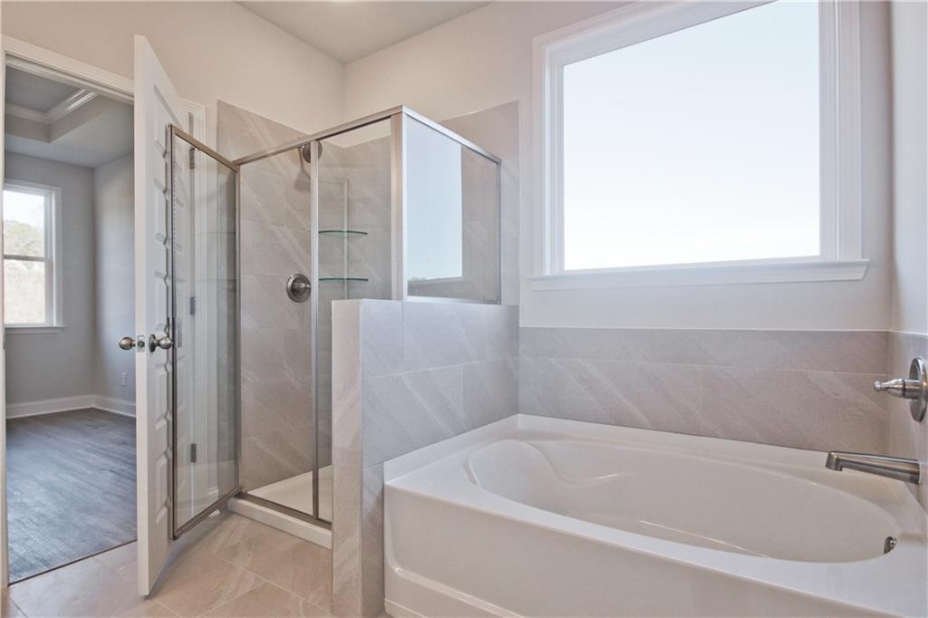 5984 Spring Way Lithonia, GA 30058 - Photo 26 of 37 a white bath tub sitting next to a shower