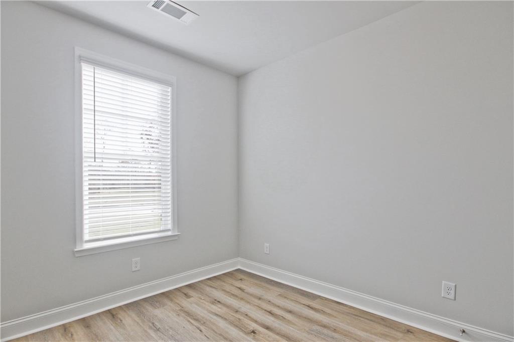 5984 Spring Way Lithonia, GA 30058 - Photo 28 of 37 a view of an empty room with wooden floor and a window