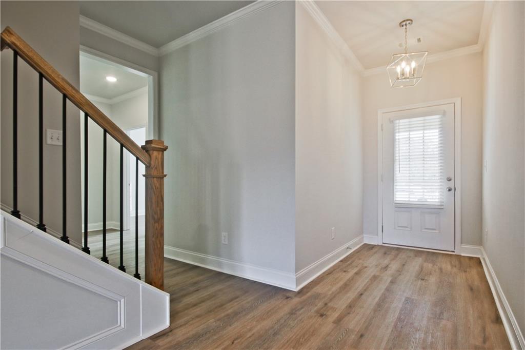 5984 Spring Way Lithonia, GA 30058 - Photo 3 of 37 a view of a hallway with wooden floor and entryway