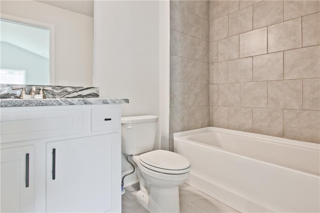 5984 Spring Way Lithonia, GA 30058 - Photo 36 of 37 a bathroom with a sink a toilet and bathtub