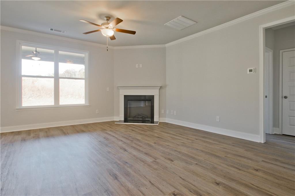 5984 Spring Way Lithonia, GA 30058 - Photo 5 of 37 a view of an empty room with wooden floor and a window