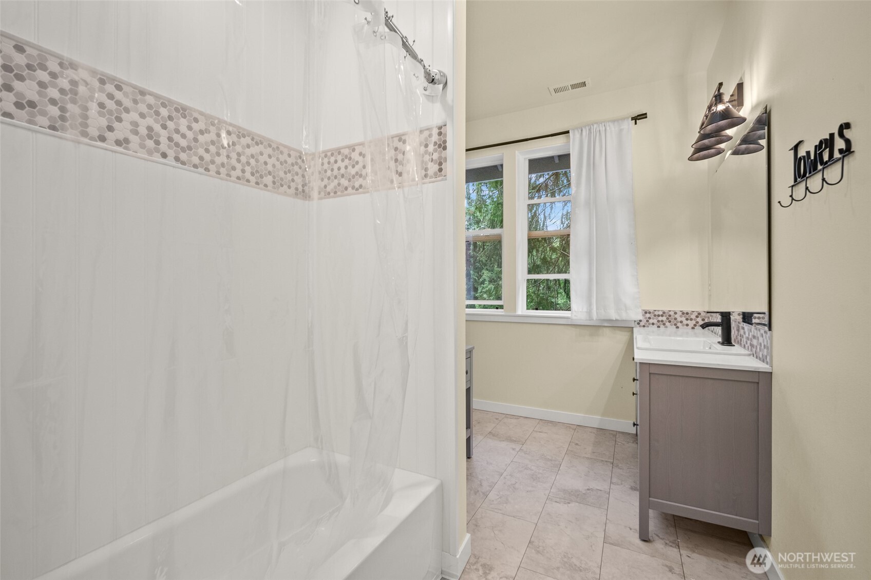 23 Spring Court Bellingham, WA 98229 - Photo 25 of 38 a bathroom with a tub a sink and mirror