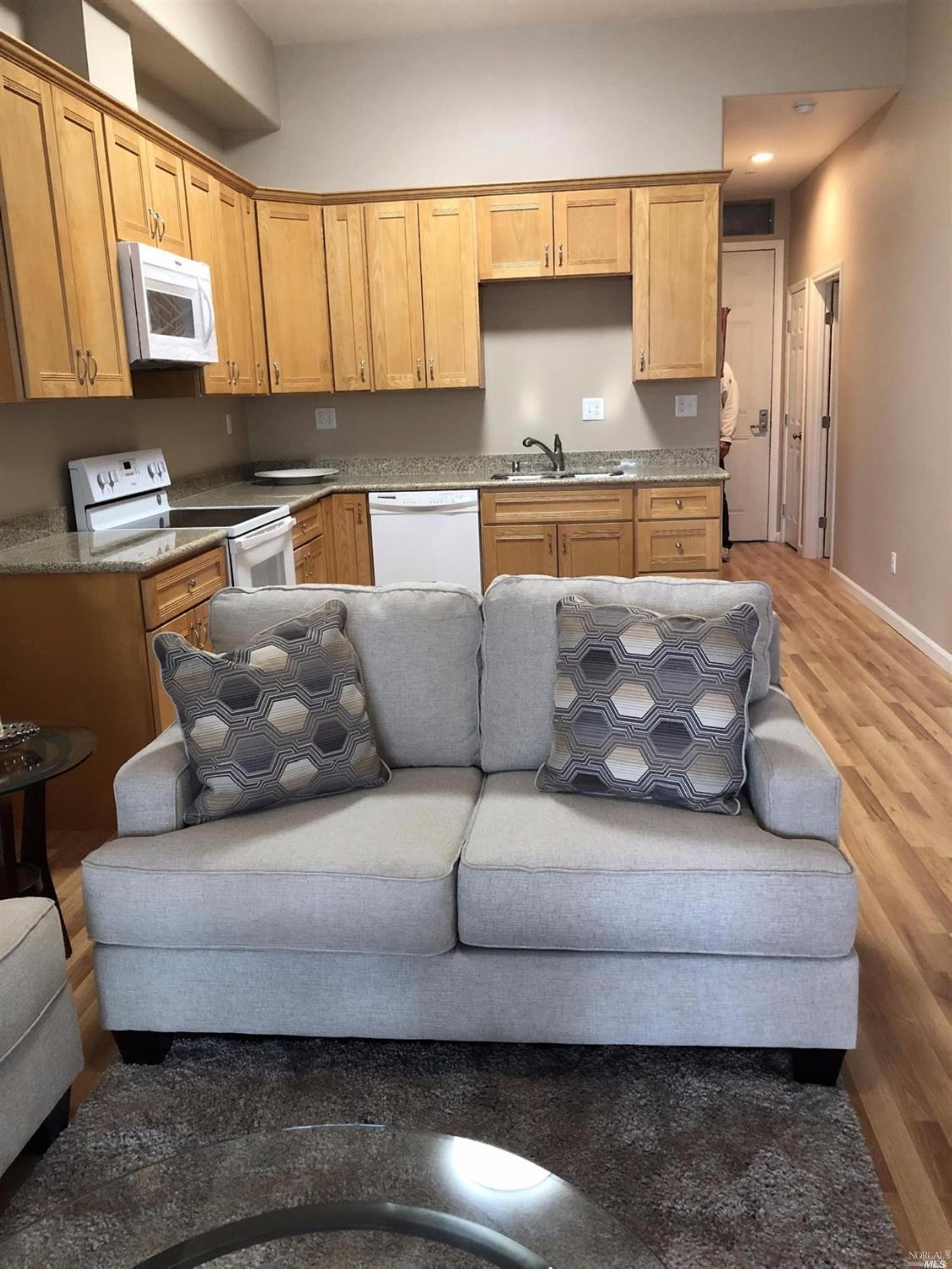 a living room with furniture fireplace and a window