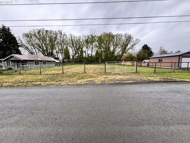 a view of a road with a small yard