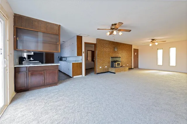 a view of a kitchen with a sink and a refrigerator