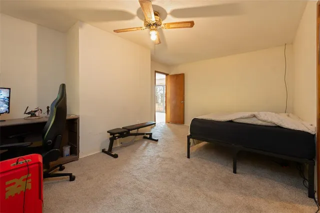 a bedroom with a bed a desk and chair