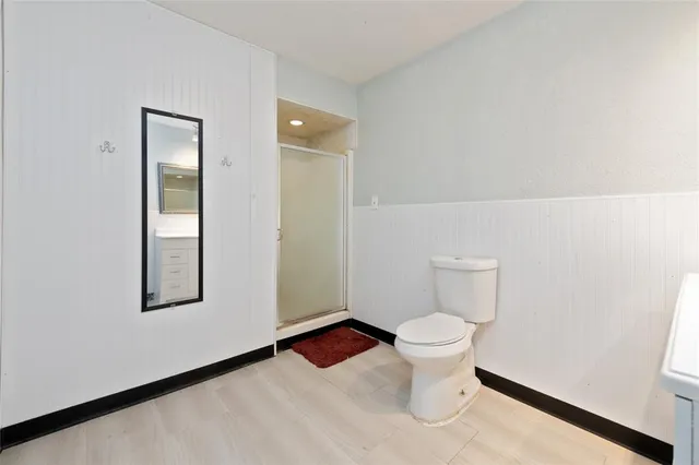 a white toilet sitting next to a bathroom sink