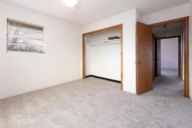 a view of an empty room with a cabinet