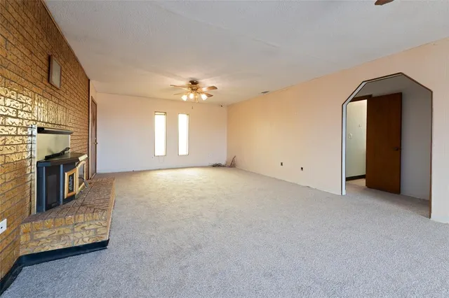 wooden floor in an empty room with a fireplace
