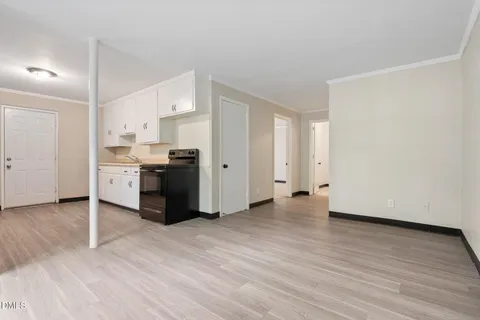 an empty room with windows and closet