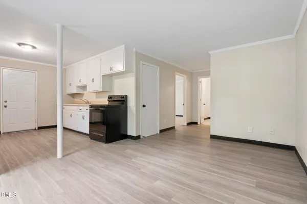 an empty room with windows and closet