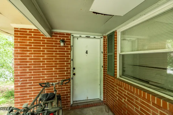 a view of a room with wooden floor and windows