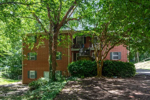 front view of a house with a tree