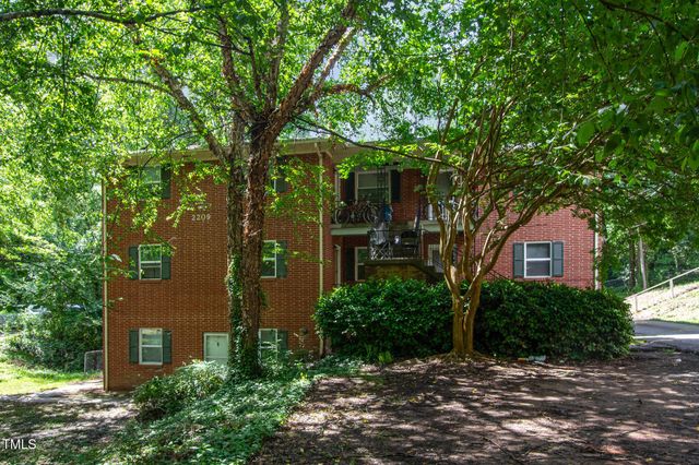 front view of a house with a tree