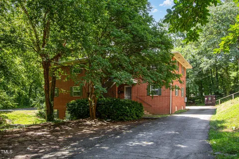 a view of a house with a yard and tree s