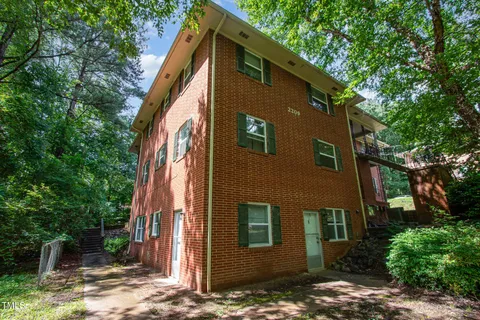 a front view of a house with trees