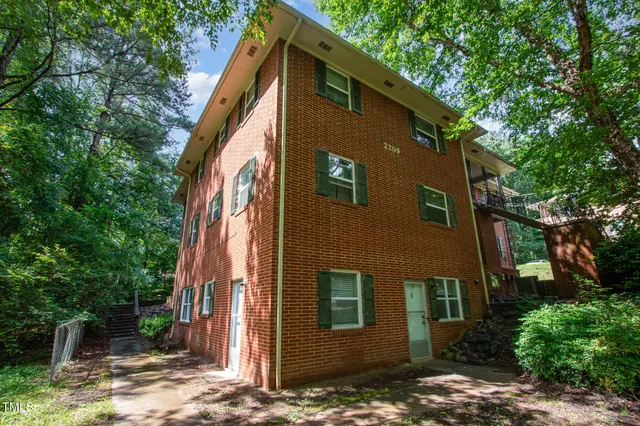 a front view of a house with trees