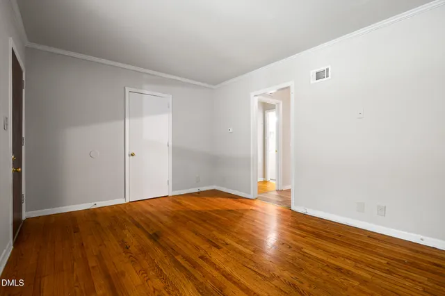 a view of a house with a yard and pathway