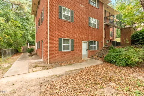 a view of a house with a yard and plants